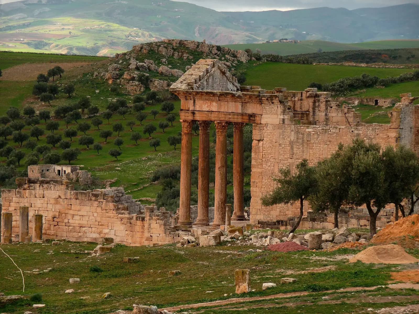 The Capitol of Dougga among olive groves, seen from the theatre