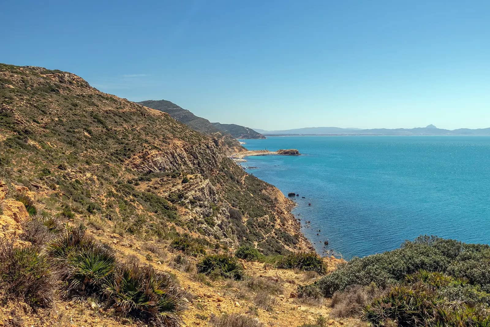 Green hills dropping into the turquoise sea on the Korbous coast