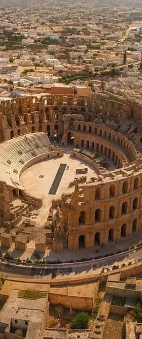 Aerial view of the El Jem amphitheatre rising above the town on a Kairouan and El Jem tour